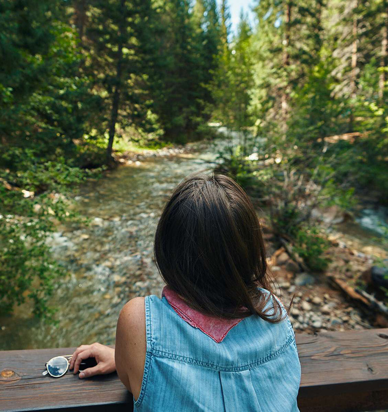 Woman looking out at a creek